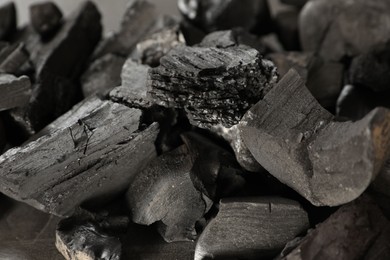 Photo of Pieces of black coals on table, closeup