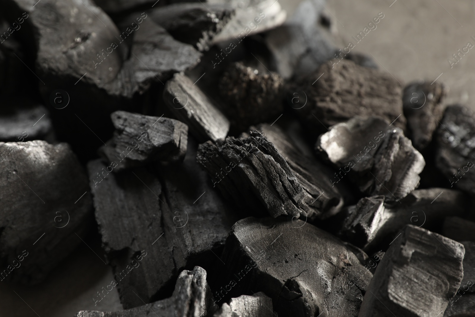Pieces of black coals on table, closeup Photo of Pieces of black coals on table, closeup