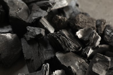 Photo of Pieces of black coals on table, closeup