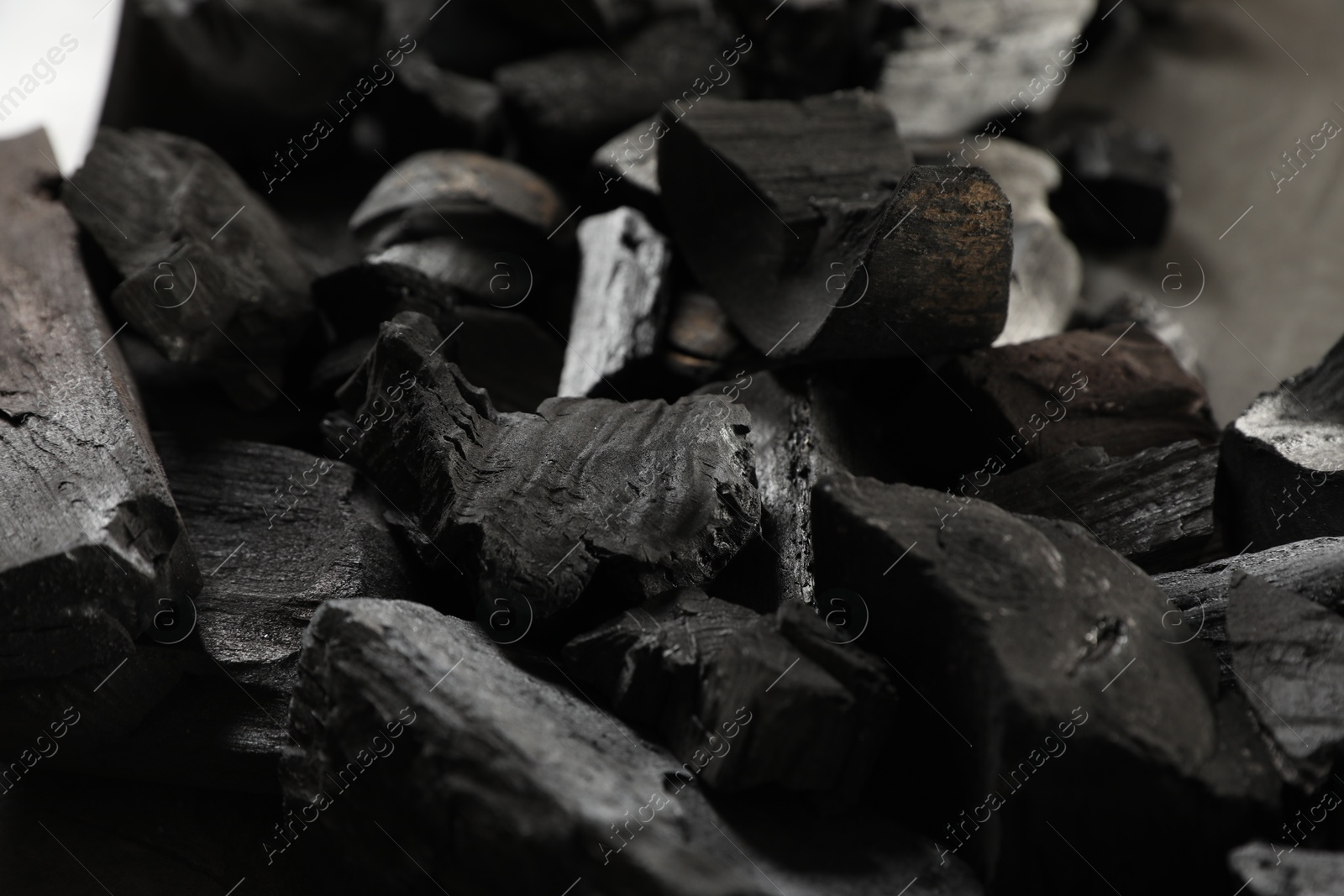 Pieces of black coals on table, closeup Photo of Pieces of black coals on table, closeup