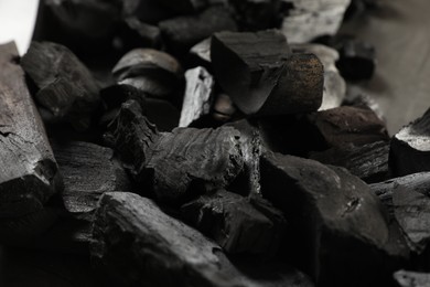 Photo of Pieces of black coals on table, closeup