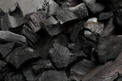 Photo of Pieces of black coals as background, top view
