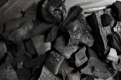 Photo of Pieces of black coals as background, top view