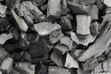 Photo of Pieces of black coals as background, top view