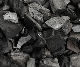 Photo of Pieces of black coals as background, top view