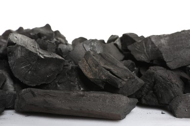 Photo of Pieces of black coals on white background