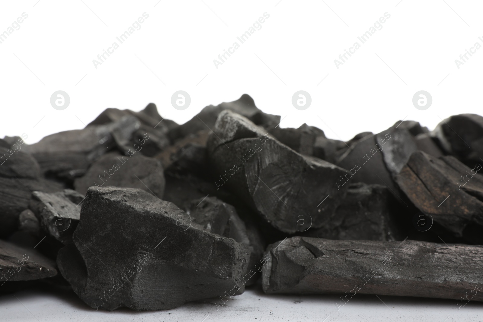 Pieces of black coals on white background Photo of Pieces of black coals on white background