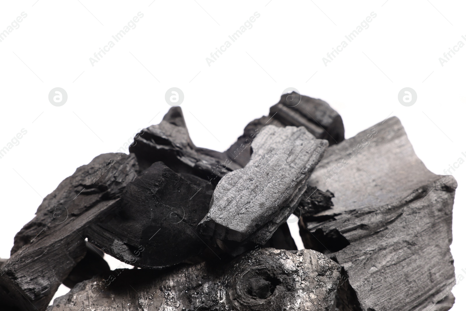 Pieces of black coals on white background Photo of Pieces of black coals on white background