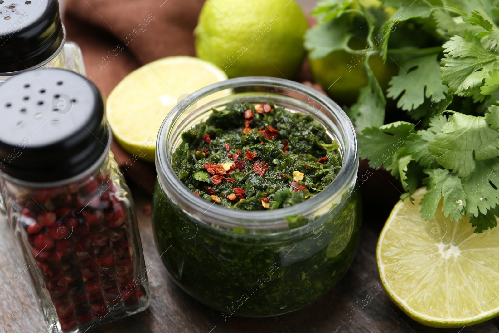 Tasty sauce with cilantro and other ingredients on table, closeup Photo of Tasty sauce with cilantro and other ingredients on table, closeup