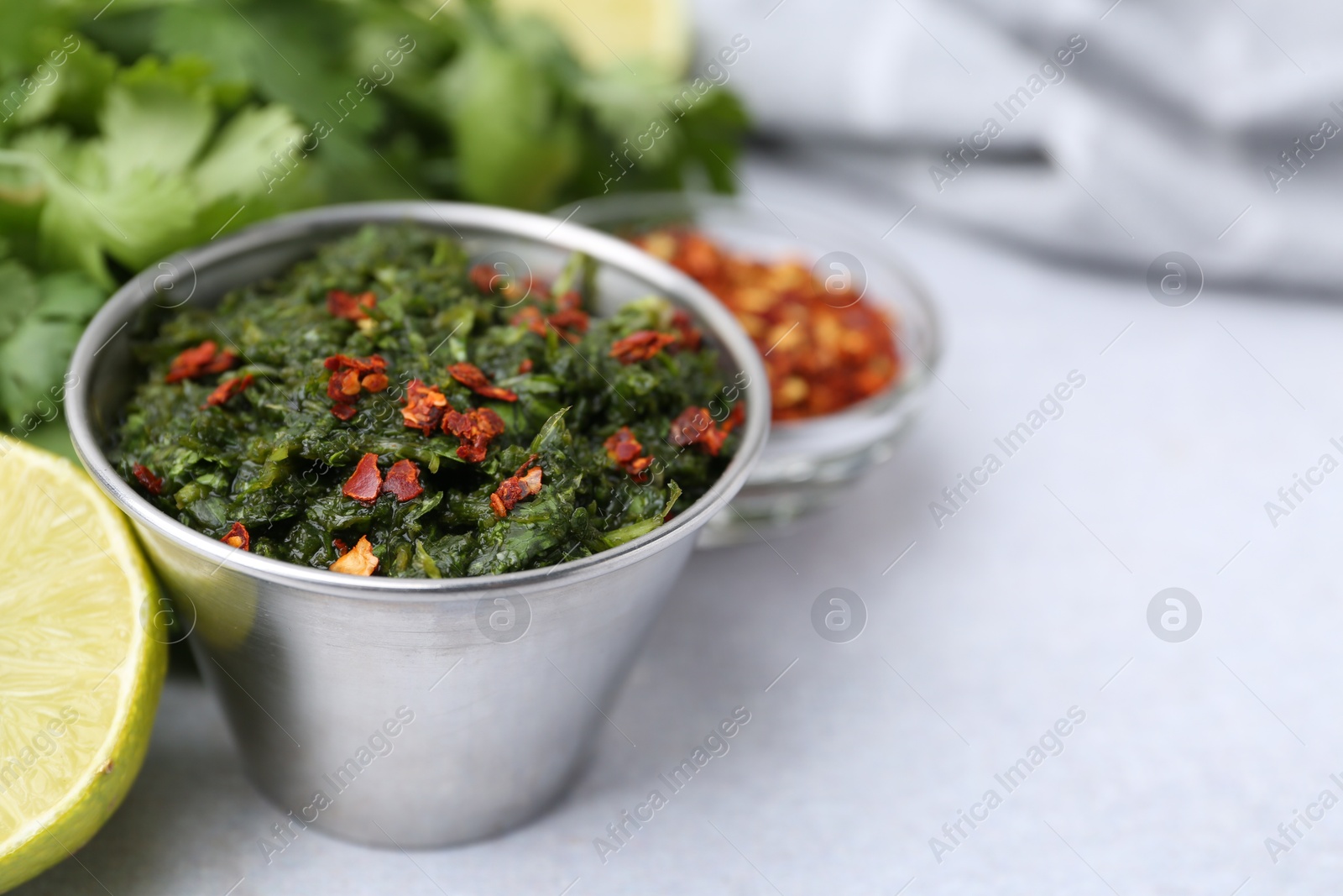Tasty sauce with cilantro and other ingredients on light table, closeup. Space for text Photo of Tasty sauce with cilantro and other ingredients on light table, closeup. Space for text