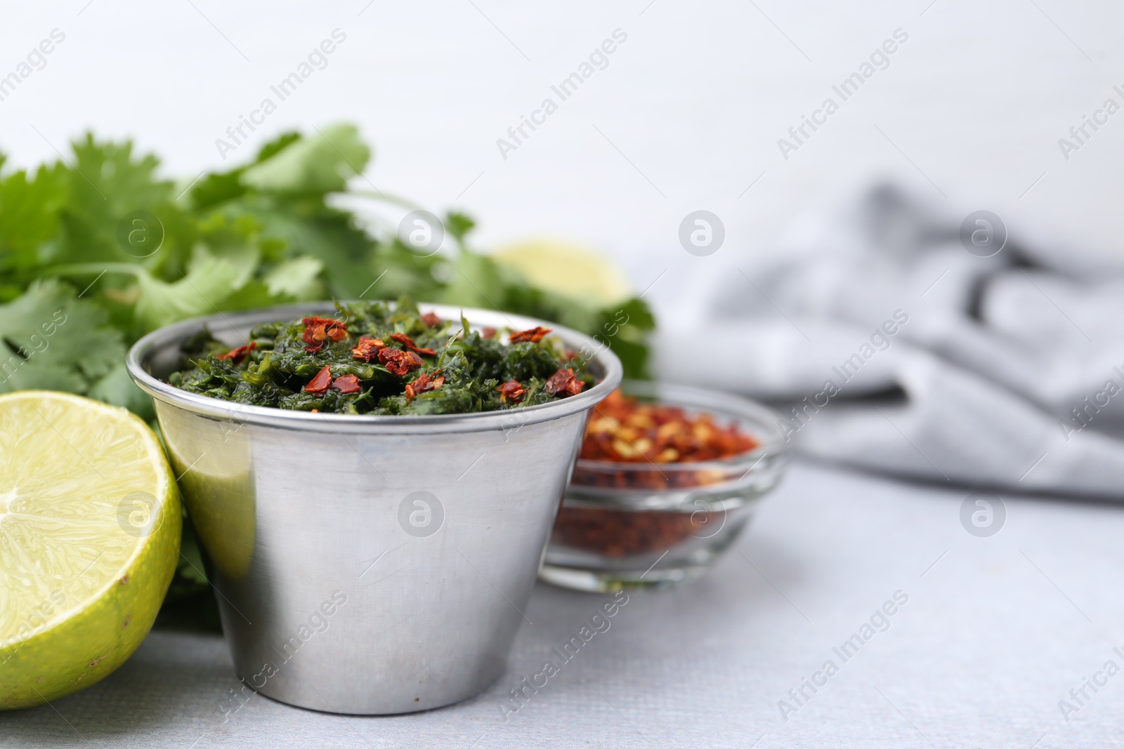 Tasty sauce with cilantro and other ingredients on light table, closeup. Space for text Photo of Tasty sauce with cilantro and other ingredients on light table, closeup. Space for text
