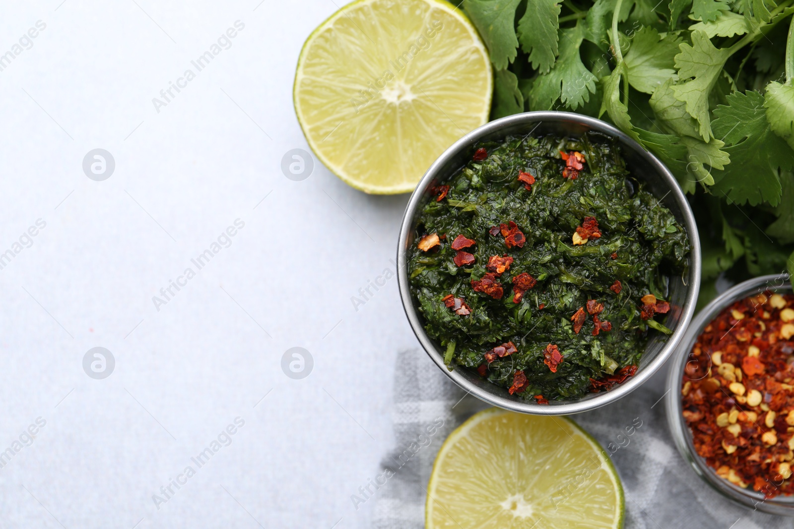 Tasty sauce with cilantro and other ingredients on light table, flat lay. Space for text Photo of Tasty sauce with cilantro and other ingredients on light table, flat lay. Space for text