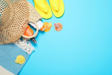 Photo of Flat lay composition with beach towel and other summer accessories on light blue background. Space for text