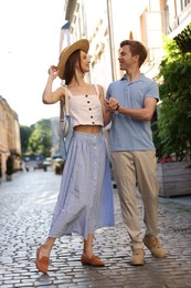 Photo of Lovely couple walking together on city street