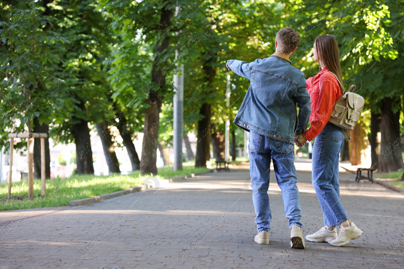 Lovely couple walking together in park, space for text Photo of Lovely couple walking together in park, space for text