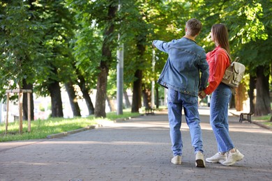 Photo of Lovely couple walking together in park, space for text