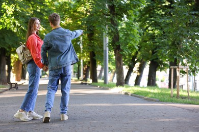 Photo of Lovely couple walking together in park, space for text