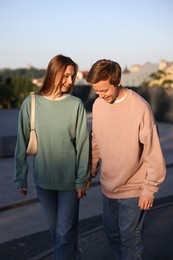 Photo of Lovely couple walking together on city street