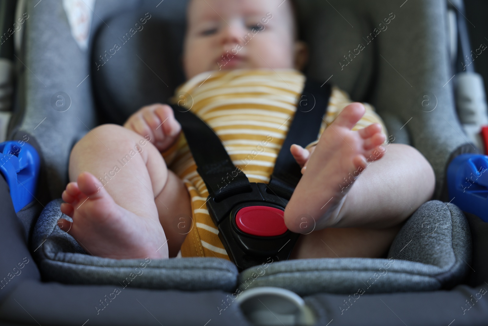 Cute little baby fastened in car seat, selective focus Photo of Cute little baby fastened in car seat, selective focus