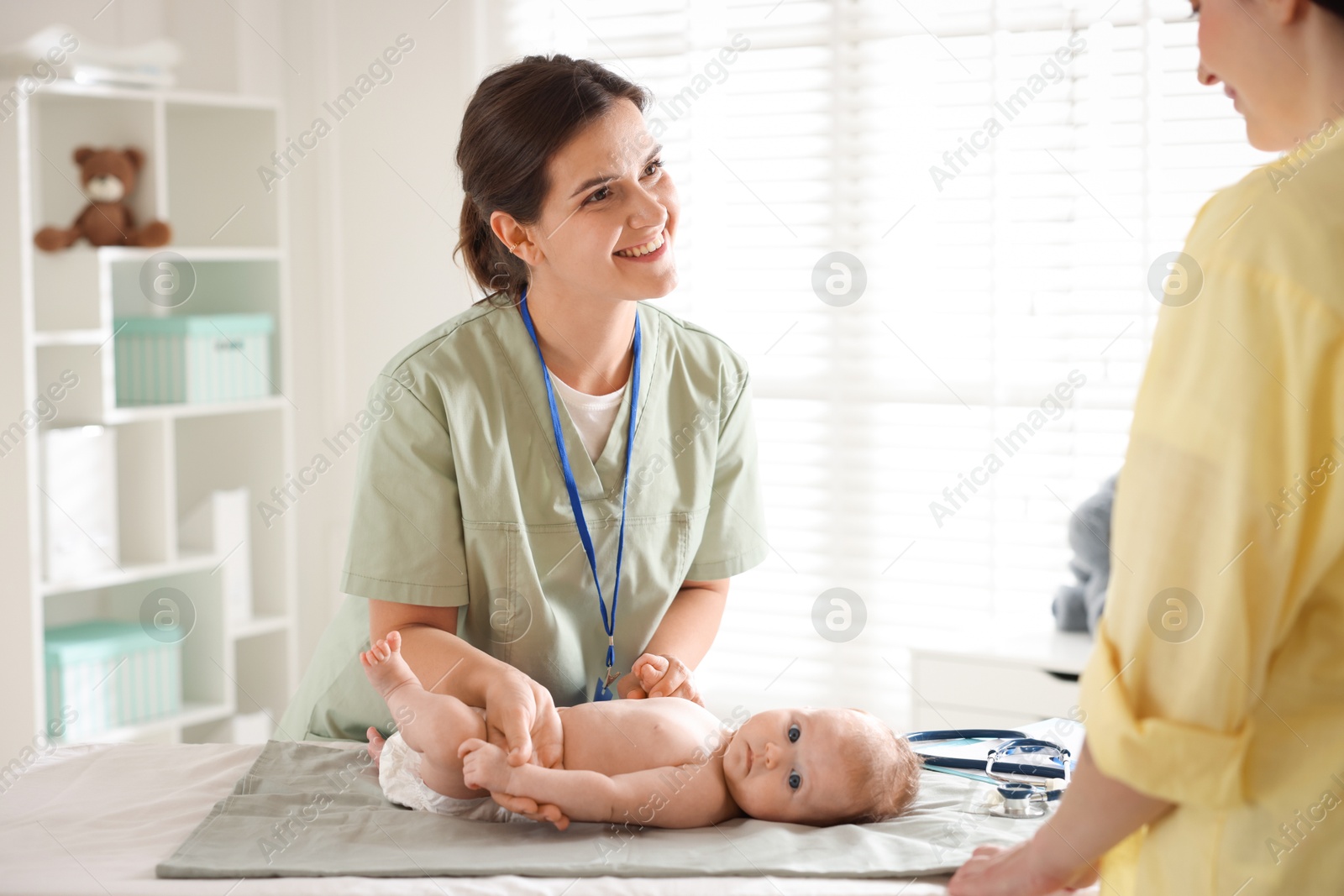 Mother and her cute baby having appointment with pediatrician in hospital Photo of Mother and her cute baby having appointment with pediatrician in hospital