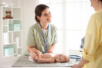 Photo of Mother and her cute baby having appointment with pediatrician in hospital