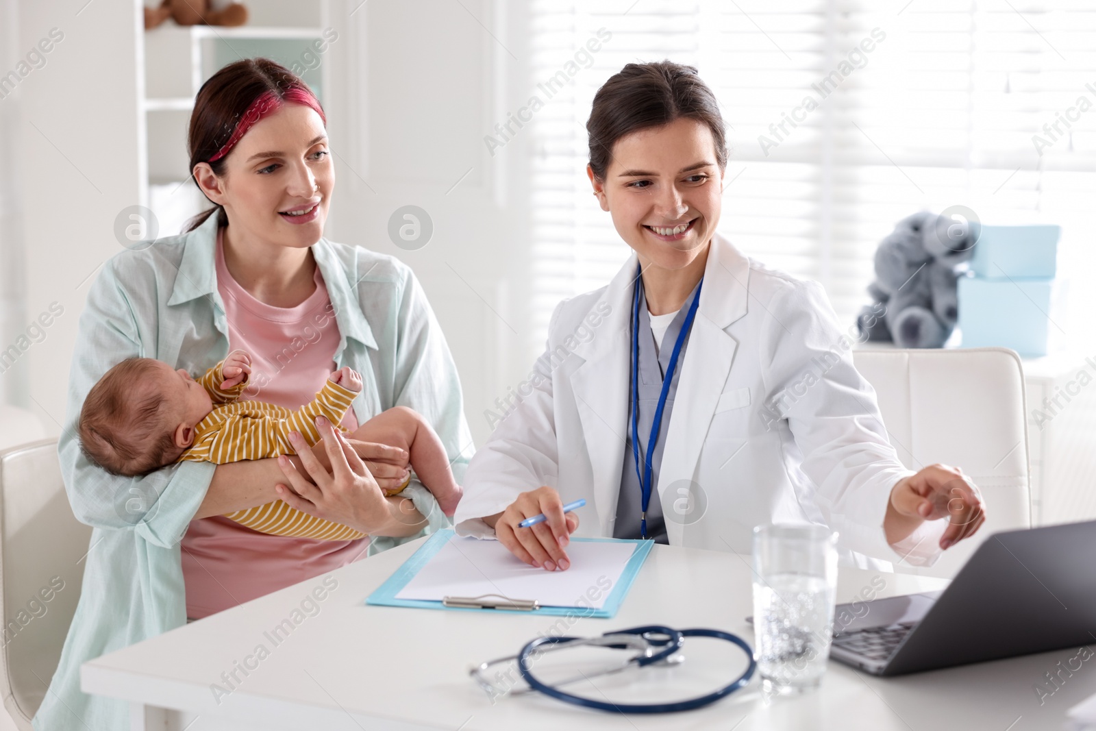 Mother and her cute baby having appointment with pediatrician in hospital Photo of Mother and her cute baby having appointment with pediatrician in hospital