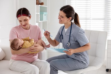 Photo of Mother and her cute baby having appointment with pediatrician in hospital