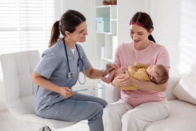 Photo of Mother and her cute baby having appointment with pediatrician in hospital