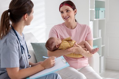 Photo of Mother and her cute baby having appointment with pediatrician in hospital