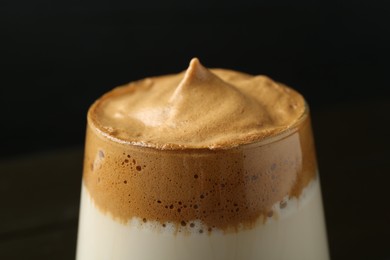 Photo of Delicious dalgona coffee in glass on blurred background, closeup