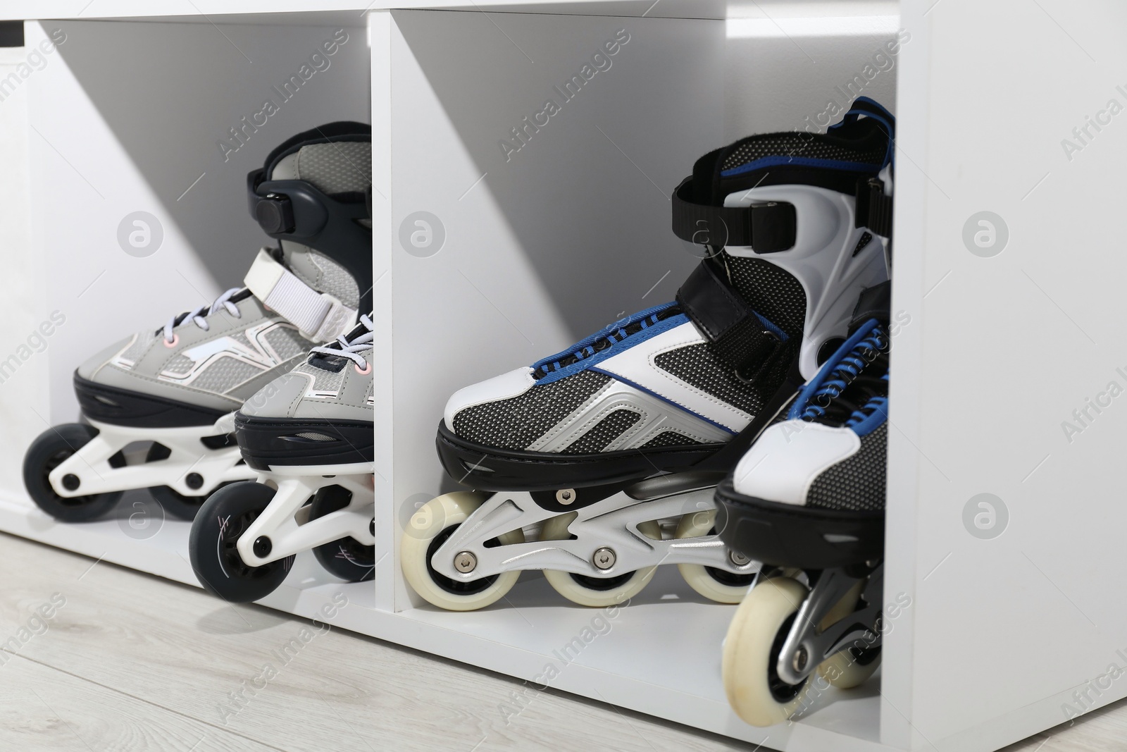 Pairs of roller skates in shelving unit, closeup Photo of Pairs of roller skates in shelving unit, closeup
