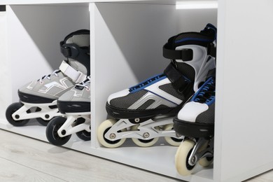 Photo of Pairs of roller skates in shelving unit, closeup