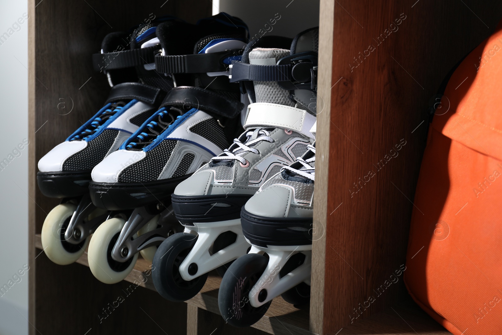 Pairs of roller skates in shelving unit, closeup Photo of Pairs of roller skates in shelving unit, closeup