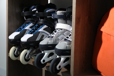 Photo of Pairs of roller skates in shelving unit, closeup