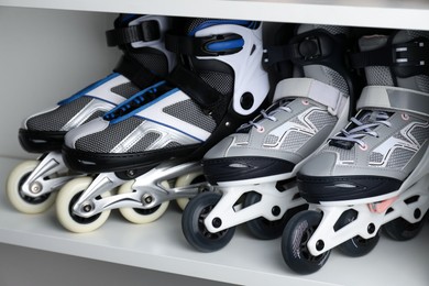 Photo of Pairs of roller skates in shelving unit, closeup