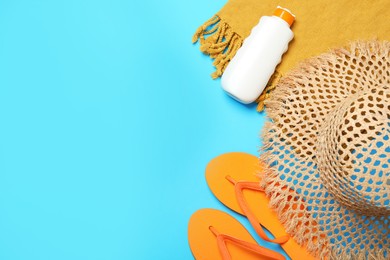 Photo of Flat lay composition with beach towel and other summer accessories on light blue background. Space for text