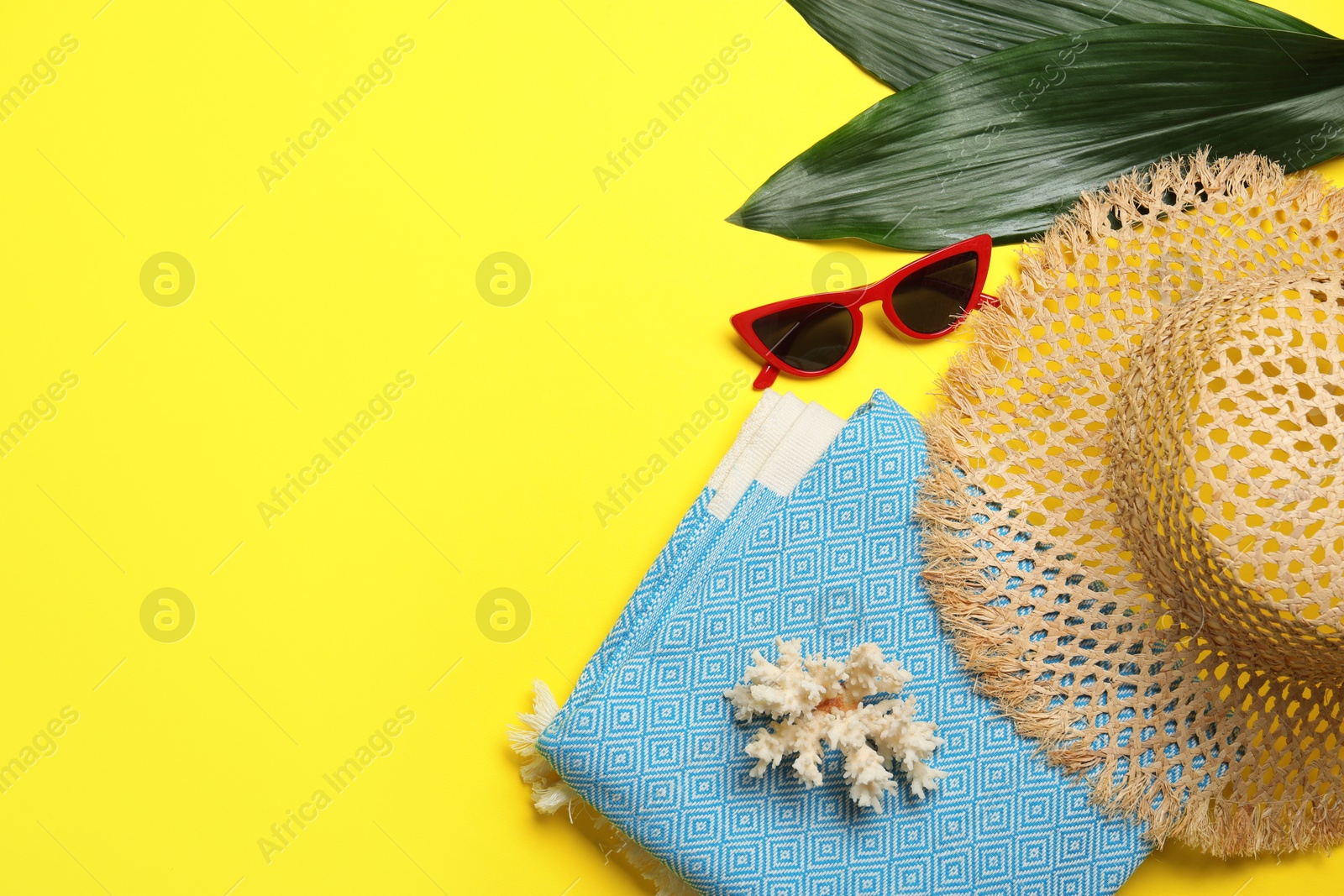 Flat lay composition with beach towel and other summer accessories on yellow background. Space for text Photo of Flat lay composition with beach towel and other summer accessories on yellow background. Space for text