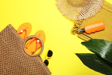 Photo of Flat lay composition with beach towel and other summer accessories on yellow background