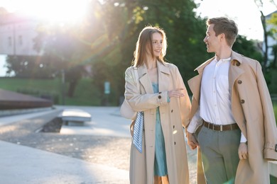 Photo of Lovely couple walking together on city street, space for text