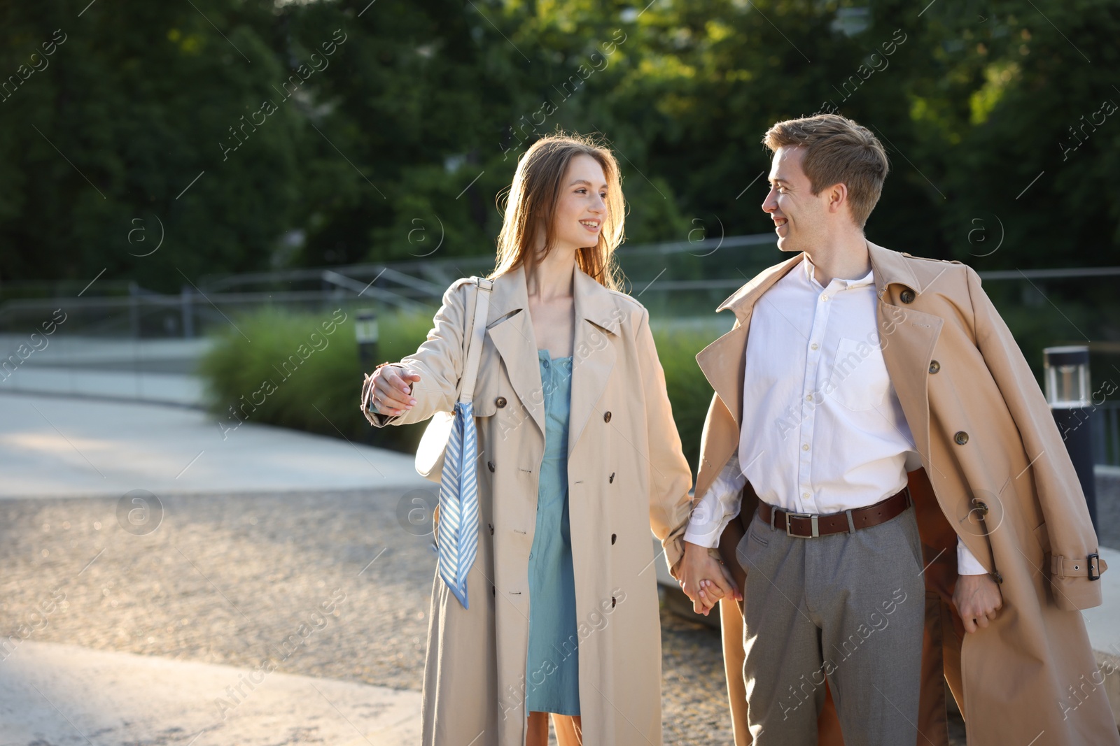 Lovely couple walking together on city street, space for text Photo of Lovely couple walking together on city street, space for text