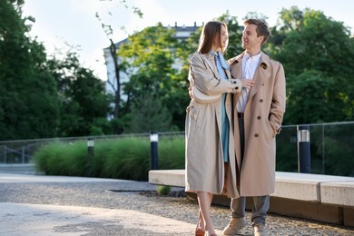Photo of Lovely couple walking together on city street, space for text