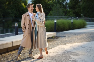 Photo of Lovely couple walking together on city street, space for text