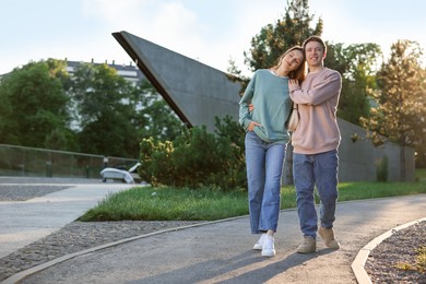 Photo of Lovely couple walking together in park, space for text