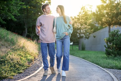 Photo of Lovely couple walking together in park on sunny day
