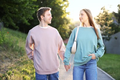 Photo of Lovely couple walking together in park on sunny day