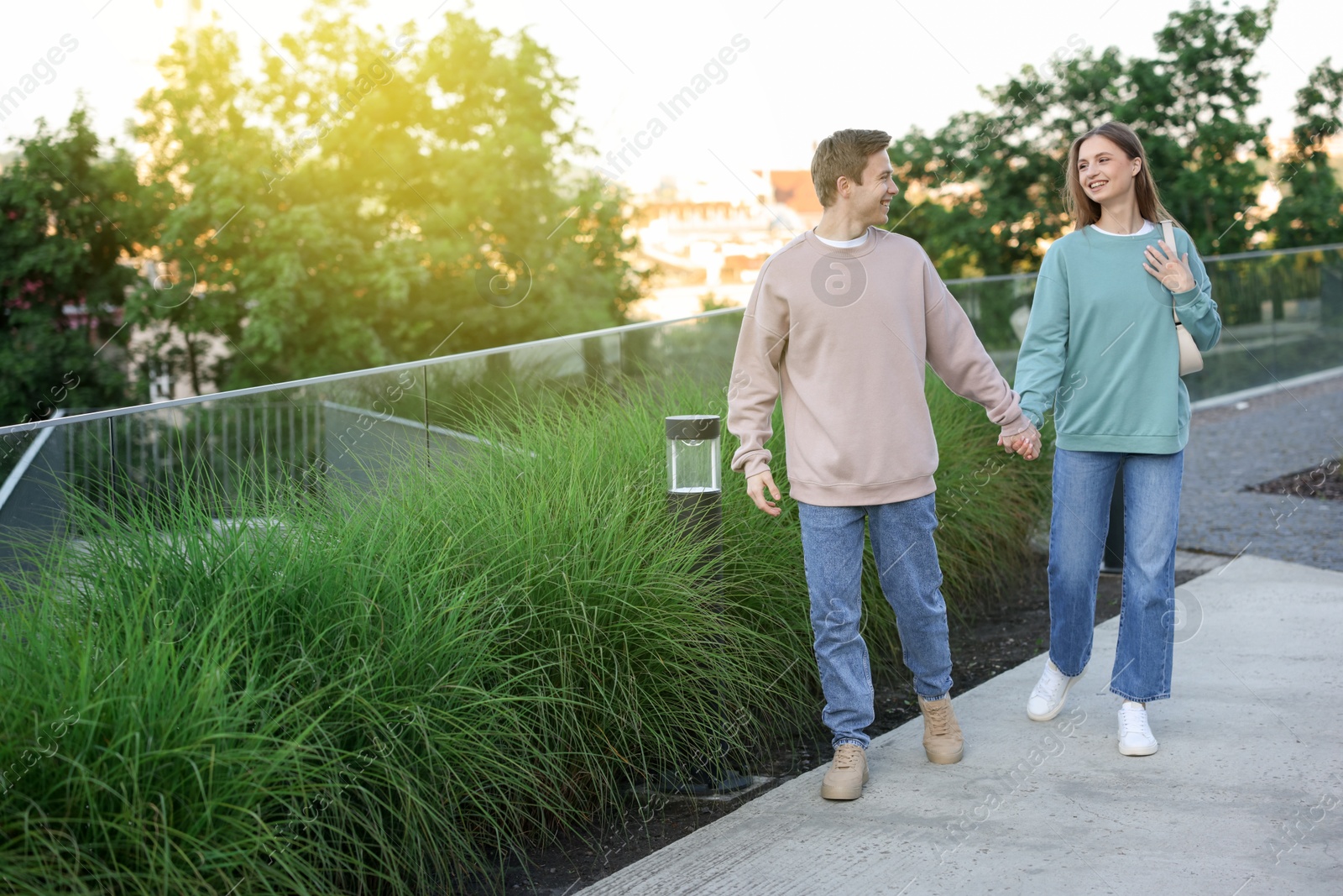 Lovely couple walking together on city street Photo of Lovely couple walking together on city street