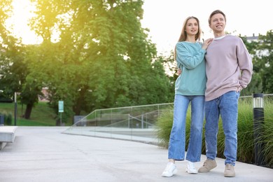 Photo of Lovely couple walking together on city street, space for text