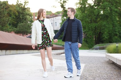 Photo of Lovely couple walking together on city street