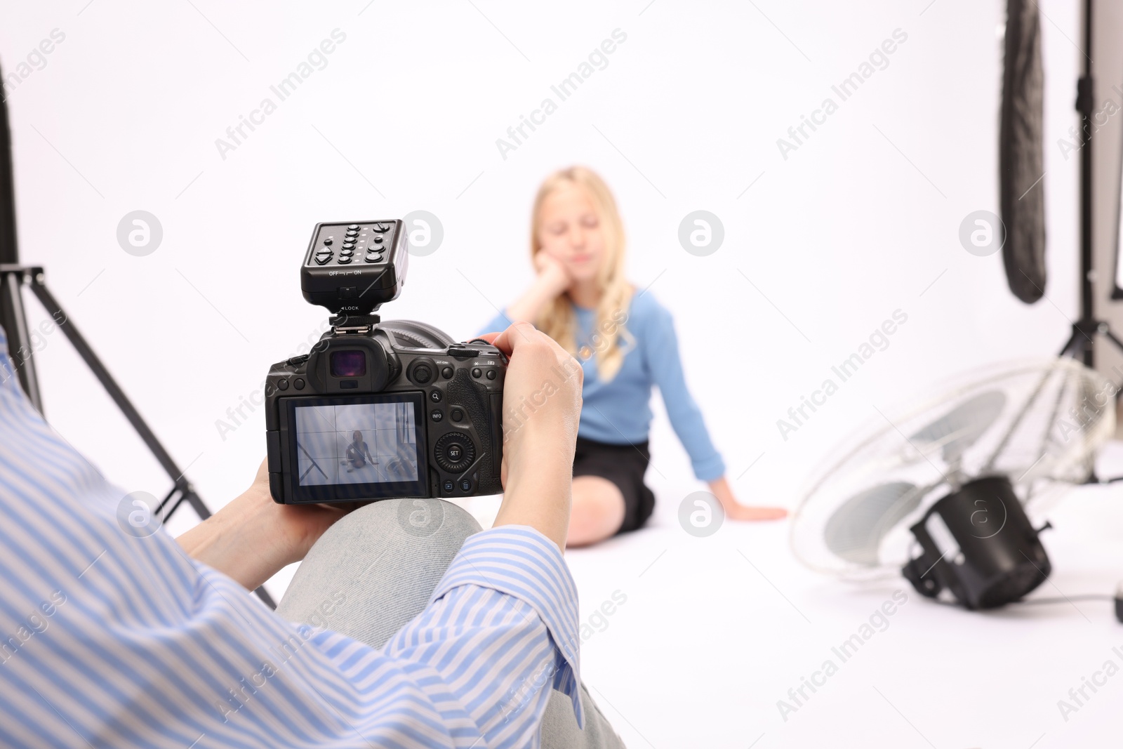 Photographer working with model in professional photo studio, selective focus Photo of Photographer working with model in professional photo studio, selective focus