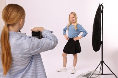 Photo of Photographer working with model in professional photo studio